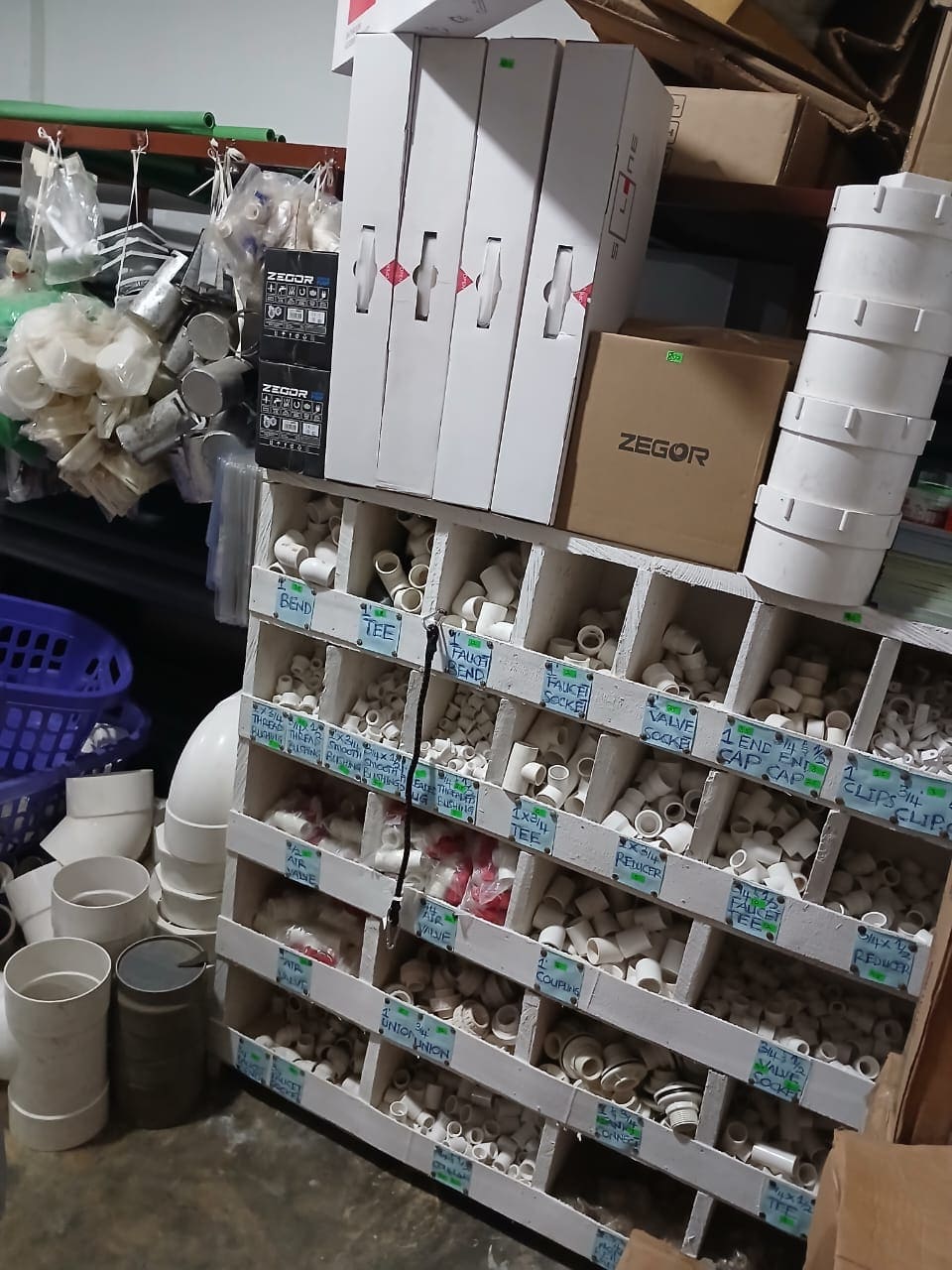 A shelf of pictures stoppers ans joint pipes
