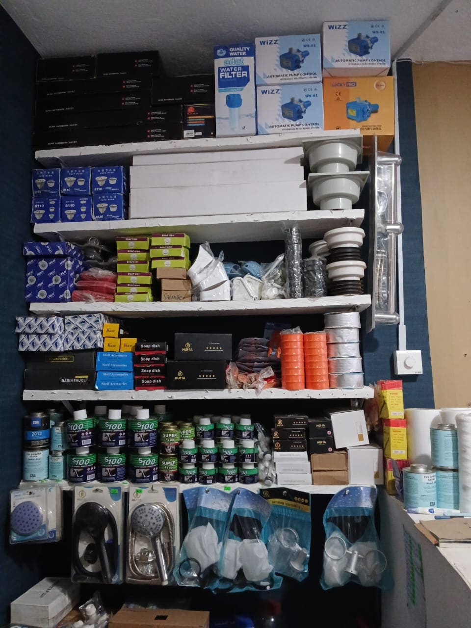 A Plumbing Shop shelf full of plumbing materials